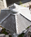 Top view of Tranquil Pagoda Solar Garden Statue with intricate details, 12-inch polyresin structure, in outdoor setting.