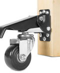 Heavy Duty Retractable Workbench Casters With Quick Release Pedals Three Inch Swivel Wheels mounted on wood beam with lock pedal.
