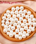 Front view: white faux pearl beads in a round wooden dish for DIY clothing accessories (150 pcs)