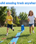 Kids playing with Portable Diy Roll Up Race Track For Kids Compatible With 1 To 64 Scale Diecast Cars Includes Eight Racing Cars And Super Grip Gravity Ramp Totally Cool Birthday Gift For Boys And Girls Ages 3 To 8 on grass