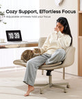 Woman relaxing in Criss Cross Office Chair With PU Leather Vanity Design, with cat on lap, in home office setting, cream.