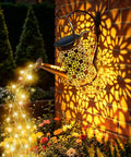Solar Watering Can Lights, Large Retro Metal Hanging Outdoor LED Decor casting glow on garden, warm white light, waterproof