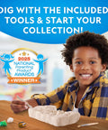 Child excavating gemstones from Dig Up 10 Real Gemstones Like A Boss Geologist With This Kid Friendly Gemstone Dig Kit at table.