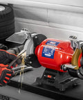 Workhorse 150Mm Bench Grinder Equipped With A Beefy 450W Induction Motor grinding metal with sparks flying.