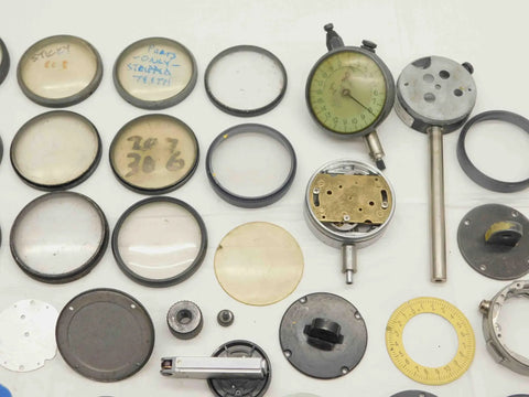 Solid Haul Of Dial Test Indicator Spare Parts And Heavy Duty Hardware For Precision Measuring Tools BR11576CZ5 assorted metal and glass components laid out for precision measurement