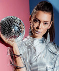 Person holding disco ball, wearing metallic outfit, showcasing Self Adhesive Disco Mirror Mosaic Tiles For DIY Craft Projects Silver 5x5mm