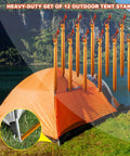 12 Pack Tent Stakes Made From 7075 Aluminum, ultra lightweight, sturdy ground pegs displayed near an orange camping tent by a lake