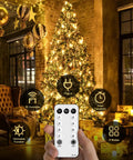 168Ft Outdoor LED String Lights With 600 Warm White LEDs on a Christmas tree in cozy room, remote in hand