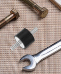 Four Piece Built For The Grind Anti Vibration Rubber Studs M10 Double Screw Mounts with bolts and wrench on a work surface.