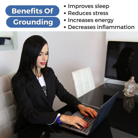 Woman using EMF Shield Grounding Kit with 2 Cords and 2 Wrist Straps for Home or Office while working on laptop