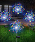 4 Pack Solar Garden Lights With 120 LED Starburst Effects illuminating a garden at night, showcasing warm white glow.