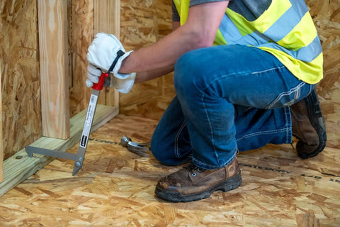Builder using Little PeeVee Sill Plate Tool For Construction Walls, 18 Inch Length Steel Puller With Ergonomic Grip on plywood floor