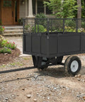 ATV Dump Cart With 1700 Lb Capacity And 17 Cu Ft Steel Bed, Removable Sides, Tow Behind Yard Beast in residential setting.