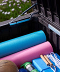 Open Beefy Westwood 150 Gallon Resin Outdoor Storage Box with exercise mats and gear inside, showing spacious storage capacity