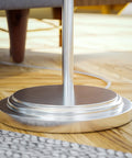 Base of Theta Swing Arm Floor Lamp With Brushed Steel Finish, modern reading light for living room or bedroom, close-up view
