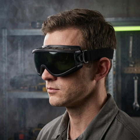 Heavy Duty Welding Goggles With Wide Dark Lens Shade And Adjustable Strap Multipurpose Safety Eyewear For Brazing Torch Cutting worn by a man.