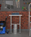 Real Deal Heavy Duty Stainless Steel Work Table With Spacious Open Base Clearance NSF Approved Utility Bench Garage And Laundry 24 Inch By 14 Inch Built Different For Serious Home Projects in a workspace with tools.