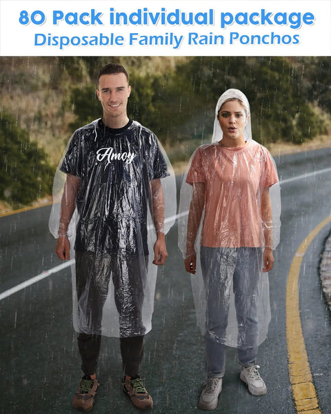 Two adults wearing clear 80 pack disposable adult rain ponchos on road, hooded with elastic cuffs for theme parks and outdoor adventures.