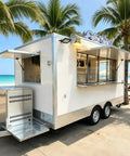 Premium White Food Truck 13ft Heavy Duty Fiberglass Mobile Beverage Cart With Cozy Seating Hella Durable Setup Designed To Serve And Dispense Fresh Drinks Smoothly at the beach with palm trees.