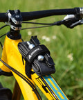 Rockband Bicycle Gear Carrier Strap In Orange No Drop Mount For Inner Tubes And Tools on a yellow bike frame