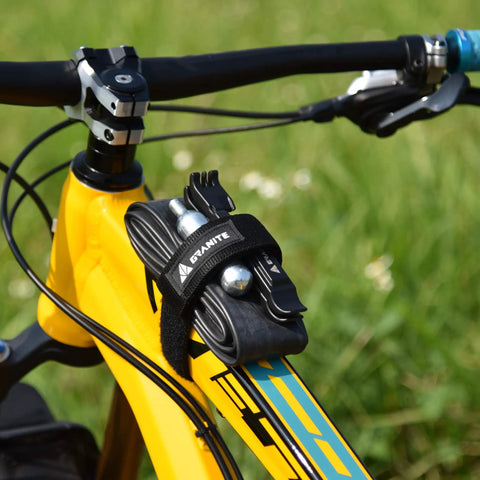 Rockband Bicycle Gear Carrier Strap In Orange No Drop Mount For Inner Tubes And Tools on a yellow bike frame