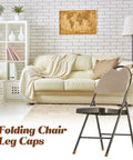 Hella Tough Brown Folding Chair Leg Caps 12 Pack Fits Like A Glove On Seven Eighth Inch Steel Tubes on a foldable chair in a living room setting.