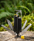 17 In 1 Multitool Pliers With Flint Fire Starter And Carabiner Hammer, 5Cr13 Steel Outdoor EDC Gear on tree stump