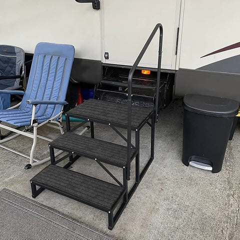 Heavy Duty Three Step RV Stair With Solid Handrail Steel Frame Rated For 600 LBS Load Capacity next to camping chair and trash can.