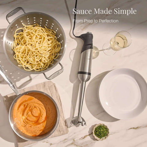 Heavy Duty Stainless Steel Immersion Blender With Kickass 600 Watt Motor And Turbo Switch with pasta and sauce in a kitchen setting.