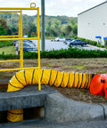 Beefy Industrial Com-Pax-Ial Blower Kit With Canister And 8 Inch By 25 Foot Duct in use, orange polyethylene housing on ground