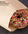 A sprinkled donut inside a brown paper sandwich bag from a 200 pack with 8 by 6 by 1 gusset sized for bakery treats, compostable.