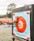 Archer practicing with 24 Inch Pro Series Big Block Foam Archery Target For Broadheads And Field Tips Ultra Durable High Density Foam