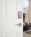 SmartCode 888 Smart Lock With Touchpad And Electronic Deadbolt Z Wave Plus SmartKey Security on white door in living room
