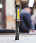 Big Larry 2 Work Light With 500 Lumens Magnetic LED Flashlight And Portable COB Task Lamp on table in workshop