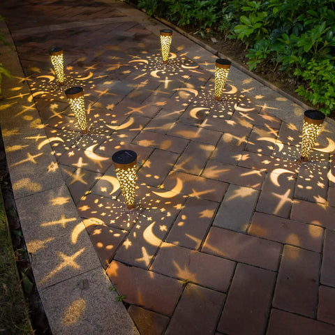 Moon Star Solar Garden Stake Lights Outdoor Waterproof Copper Finish illuminating pathway with warm patterns at night