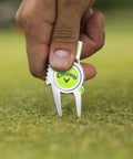 Super Handy Four In One Golf Divot Repair Tool Built With Tough Zinc Alloy for avid golfers being used on a golf course