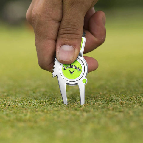 Super Handy Four In One Golf Divot Repair Tool Built With Tough Zinc Alloy for avid golfers being used on a golf course