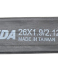 Close-up of a black Kenda tube labeled 26x1.9/2.125, fitting 26-inch MTB tires, part of Bulk Two Pack 26 By 1.90 To 2.125 Inner Tubes For Mountain Bikes With Schrader Valves Black Fits 26 Inch MTB Tire Size Range No Retail Packaging Great For Daily Trail Rides And Upgrading Your MTB Tubes.