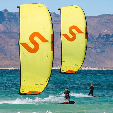 Two riders kiteboarding with Ghost V3 One Strut Kiteboarding Kite With Compact Swept Canopy For Efficient Upwind Reach, 17m yellow.