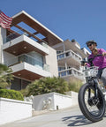 Big Time Comfort Meets Heavy Duty Power On This Fat Tire Electric Trike For Adults With 500W Motor riding by modern homes.