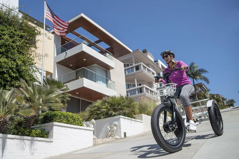 Big Time Comfort Meets Heavy Duty Power On This Fat Tire Electric Trike For Adults With 500W Motor riding by modern homes.