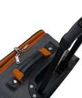 Rockland 2-piece expandable softside upright luggage set in charcoal; close-up of top handle and orange zipper pulls.