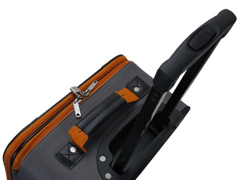 Rockland 2-piece expandable softside upright luggage set in charcoal; close-up of top handle and orange zipper pulls.