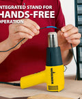 Dual Temp Heat Gun Kit with 750 Degrees F and 1000 Degrees F, three nozzles included, shown in hands-free operation on a table