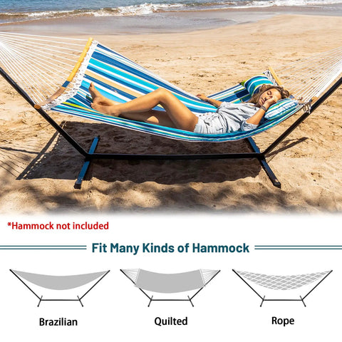 Woman relaxing on a striped hammock supported by a 12 Foot Hammock Stand For Two Built Tough, Heavy Duty Steel Frame Supports Up To 450 Lbs, Rust Resistant Black Finish, Portable Carrying Bag, Indoor Outdoor Patio Camping Gear, Durable Outdoor Hammock Stand on a beach.