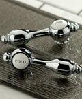 Handles of Tudor Basin Faucet in Polished Chrome Finish with Leak Free Ceramic Cartridge, Solid Brass Construction on a textured surface