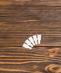 Cool DIY Fixers For Your Dinged Umbrellas: 10 Pc Plastic Stick End Caps With Snap Holes Ribs Bone Tips For Weathering Daily Commute And Shading In Style. beige plastic umbrella rib end caps on wood