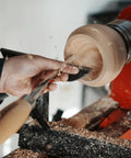 Close-up of Heavy Duty Woodturning Hollowing Tool With Replaceable Carbide Tipped Round Blade and Solid Beech Handle in use for bowl shaping.