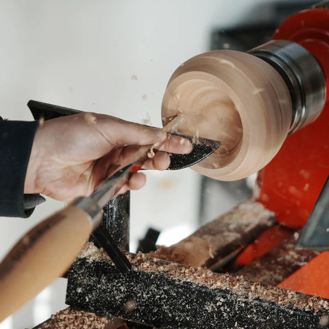 Close-up of Heavy Duty Woodturning Hollowing Tool With Replaceable Carbide Tipped Round Blade and Solid Beech Handle in use for bowl shaping.