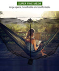 Person relaxing in hammock with Camping Hammock Net With 360 Degree Mosquito Protection, breathable mesh, on a wooden deck.
